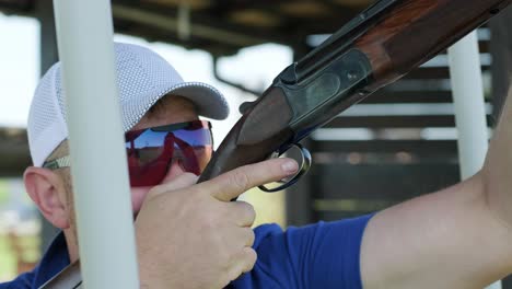 sportsman shoots from a double-barreled shotgun, a sports field for a shooting test is shooting at flying skeet