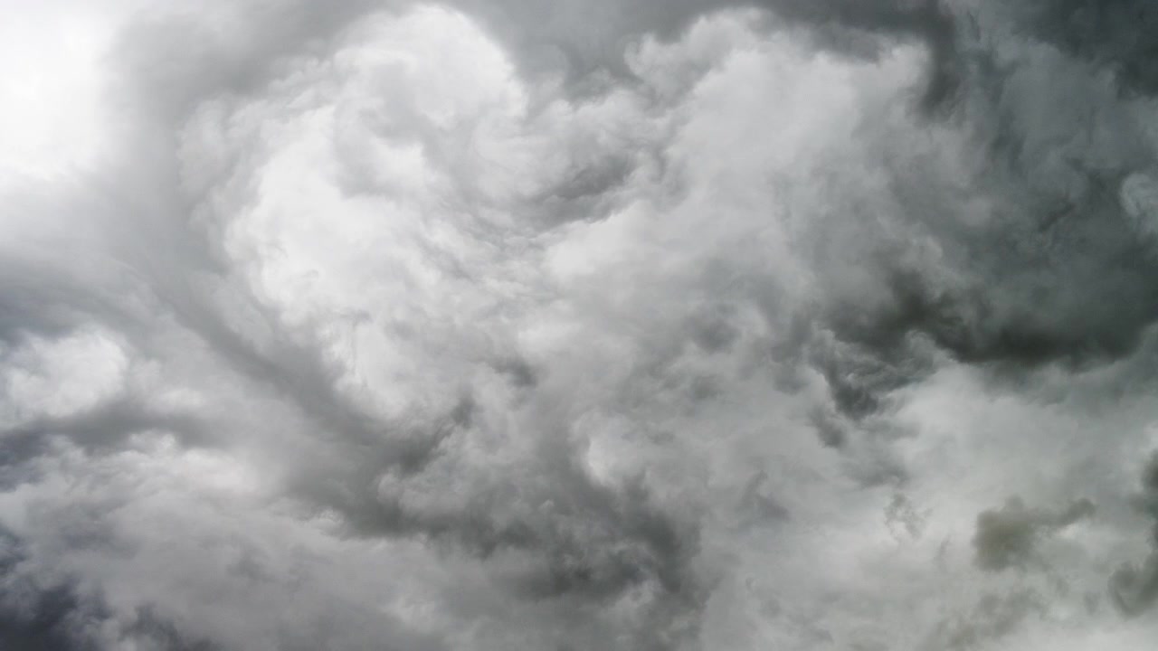 Grey thunderstorm clouds rolling overhead in an ominous weather sky scene