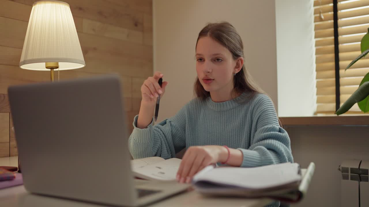 Teenage girl studying at a table