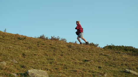 woman hiking up a hill