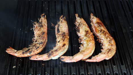 shrimp being grilled on a hot barbecue grill