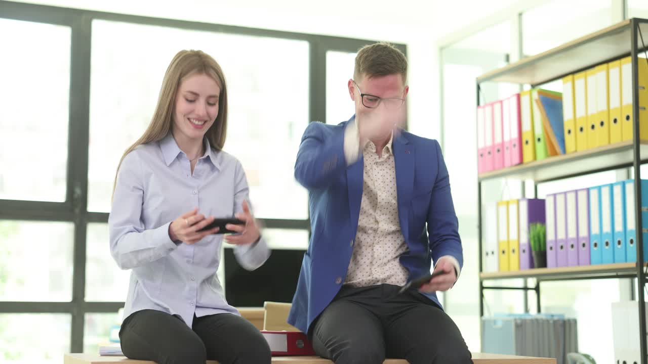 Colleagues Enjoying Mobile Games in the Office