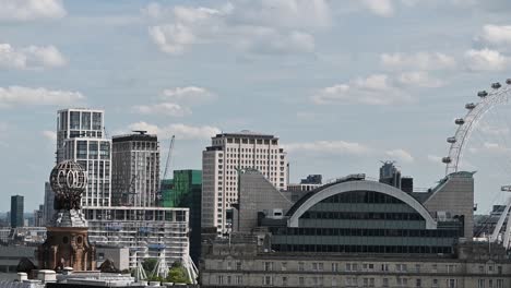 london eye behind charing cross station, london, united kingdom