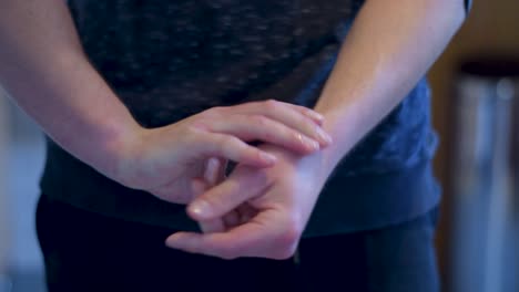 young adult man crossing hands and get disinfectant out of a dispenser to rubbing it between his hands