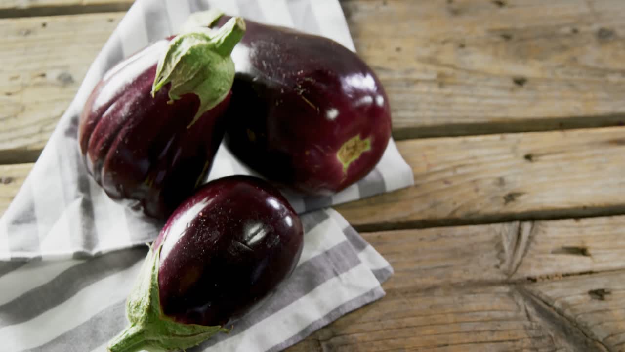 Eggplant on wooden table 4k