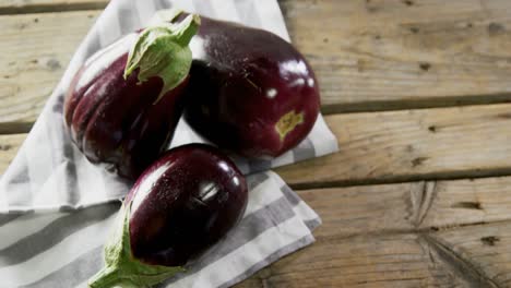 Eggplant-on-wooden-table-4k