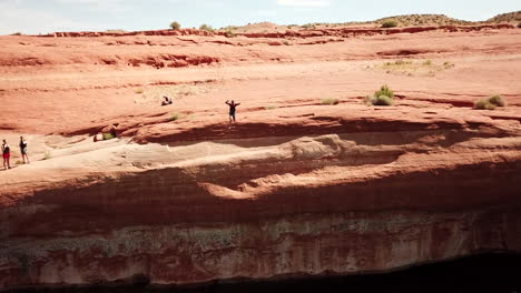 Drone shot of cliff jumper doing trick in Lake Powell Utah
