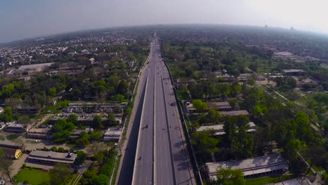 Aerial-over-the-clean-and-green-urban-city`s-highway