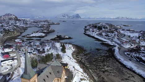 forwarding aerial shot off lofoten cathedral on a scenery moody winter day with scenic mountains, lofoten island, norway