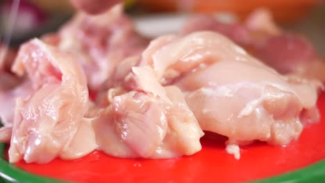 preparing raw chicken breasts for cooking