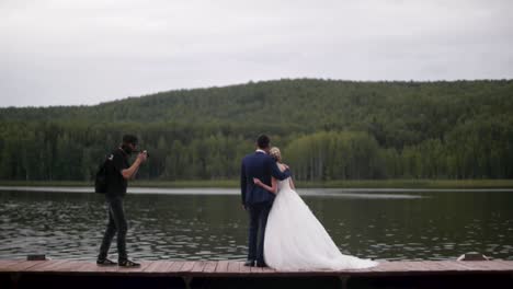 wedding couple portrait on a wooden dock by the lake