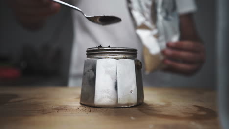 Adding-filter-coffee-powder-in-mini-espresso-maker-machine