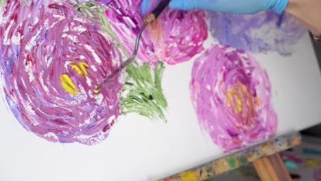 close-up of an artist painting flowers