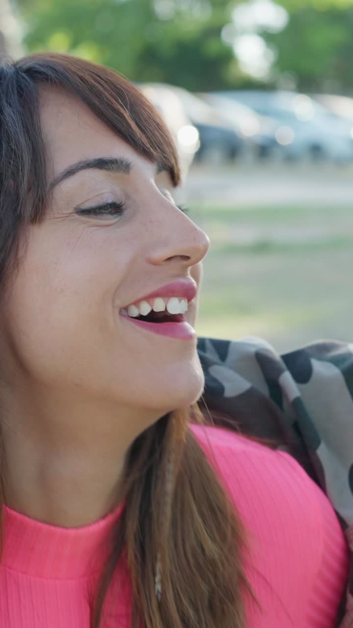 Happy Couple Laughing Outdoors in Camouflage Jackets