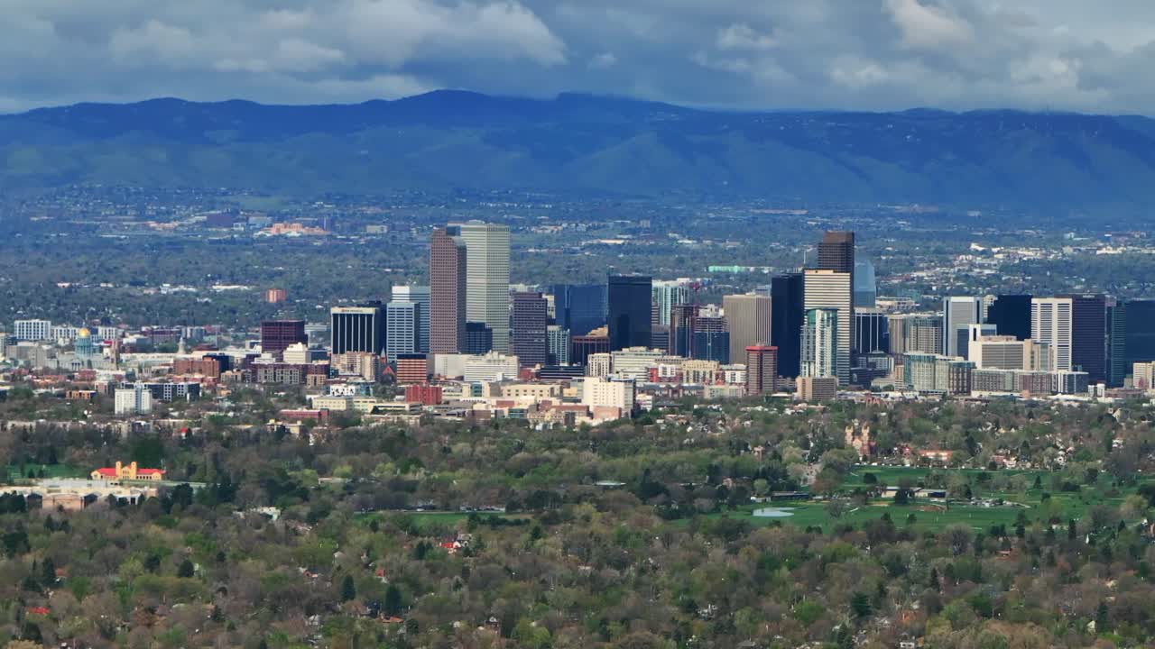 Downtown Denver skyscraper front range foothills landscape view aerial drone Colorado Northfield Stapleton Central Park spring morning rain clouds sunny cityscape Capitol building parallax circle left