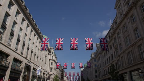 union british flags over street scene in regent street in london, england, united kingdom