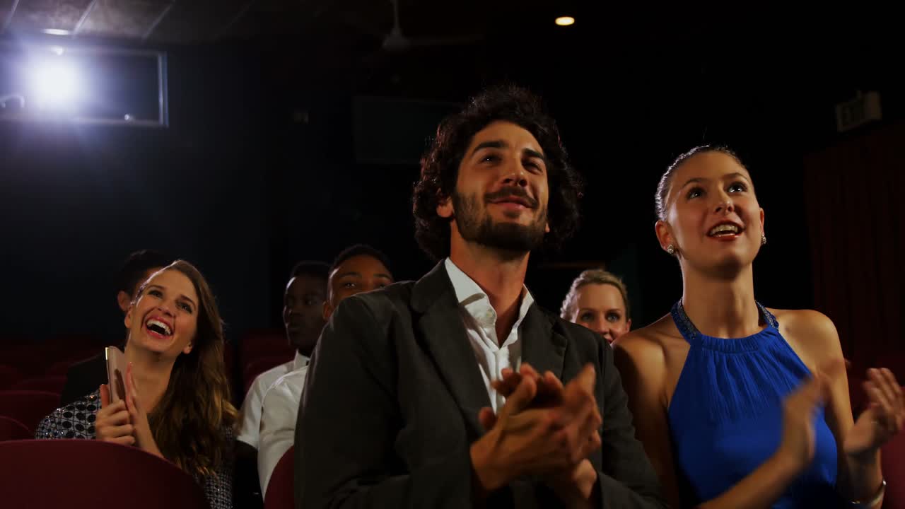 Couple applauding while watching movie 4k