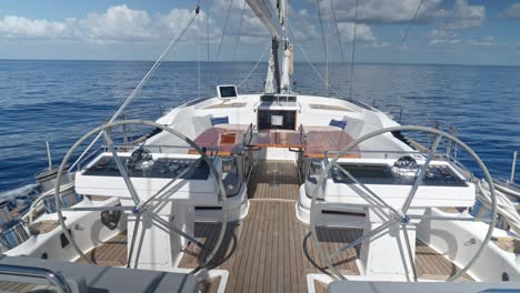 double steering wheels of oyster 82 sailboat navigating on sea water