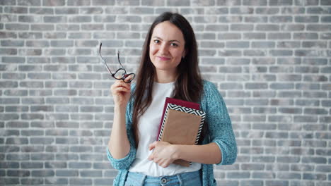 woman with books and glasses