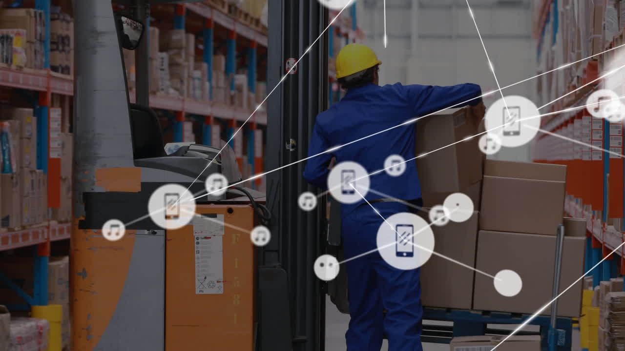 Animation of connected icons over caucasian workers placing boxes from pallet truck to forklift