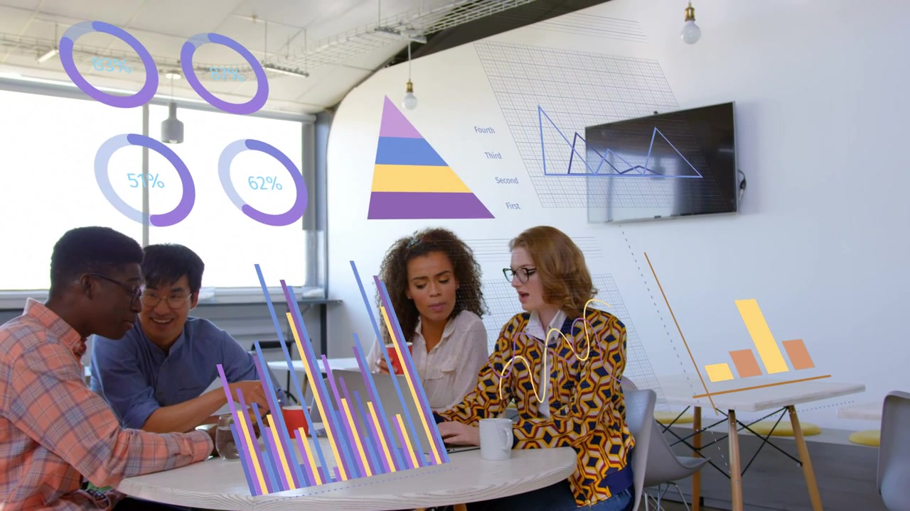 Team of four leaning at laptop, man pointing and starting data charts overlaying group for business