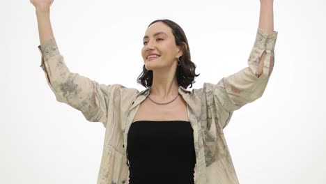 a cheerful young woman posing against a white background