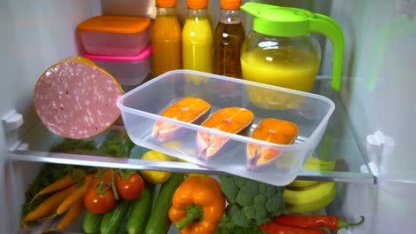 Raw-Salmon-steak-in-the-open-refrigerator