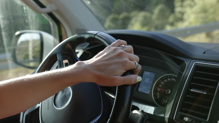 Driver's Hand on Steering Wheel in Moving Car