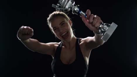 sport woman celebrating sport victory with champion trophy in hands