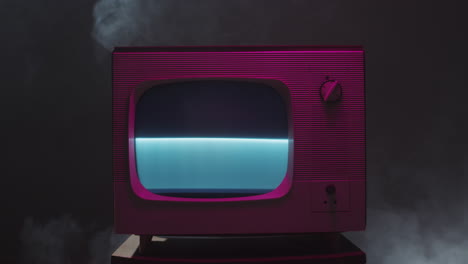 retro vintage television with blue screen and pink lighting