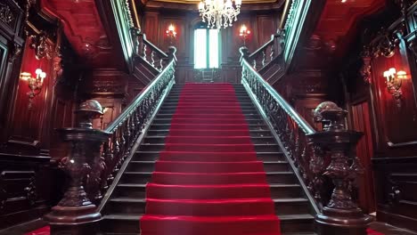 a red carpeted stairway leading up to the top of a building