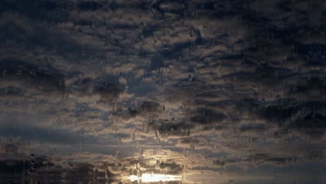 Cloud-formation-at-sunset-with-rain-effect-tilting-shot-background
