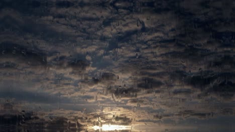 cloud formation at sunset with rain effect tilting shot background