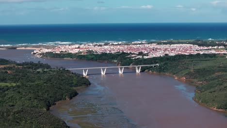 aerial view of a coastal town with a bridge over a river in portugal