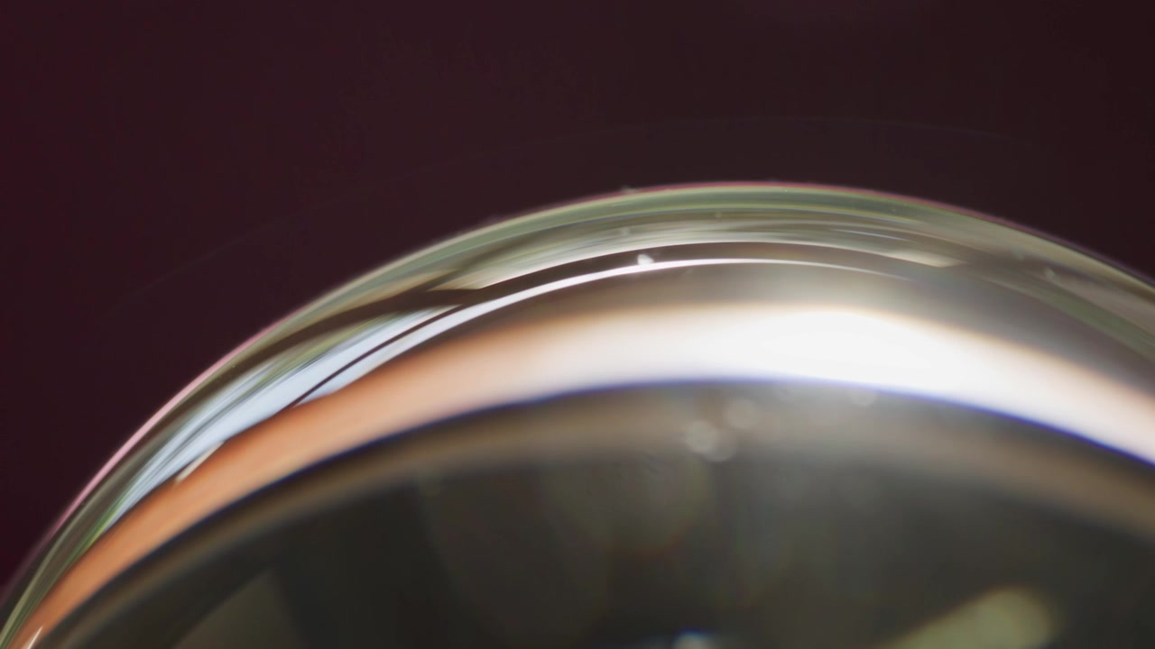 Macro Abstract Glass Orb Reflecting Sunlight, Spinning Slowly
