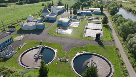 aerial view of wastewater treatment plant with green grass