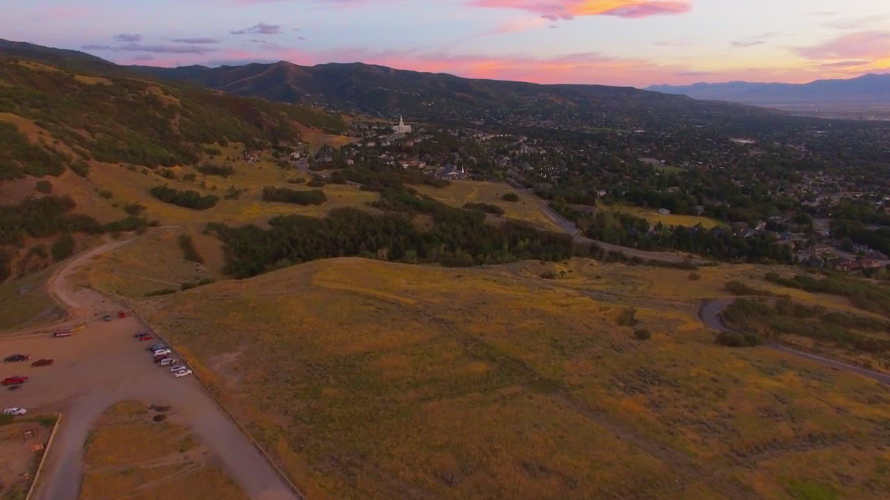 A drone flies up by a letter B situated on a mountain in the hills of Bountiful Utah overseeing the whole city and Bountiful temple