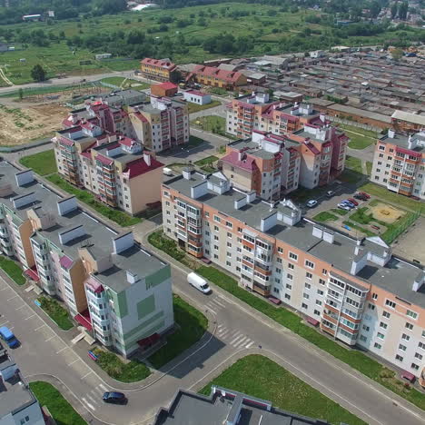 new residental building appartments in modern complex near the green fields in summer. beautiful flying over the city in a new district. aerial view