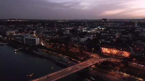 Drohne-at-night-showing-Mainz-with-the-Rhine-river,-the-castle-and-the-Dome-in-the-Background-in-a-wider-shot