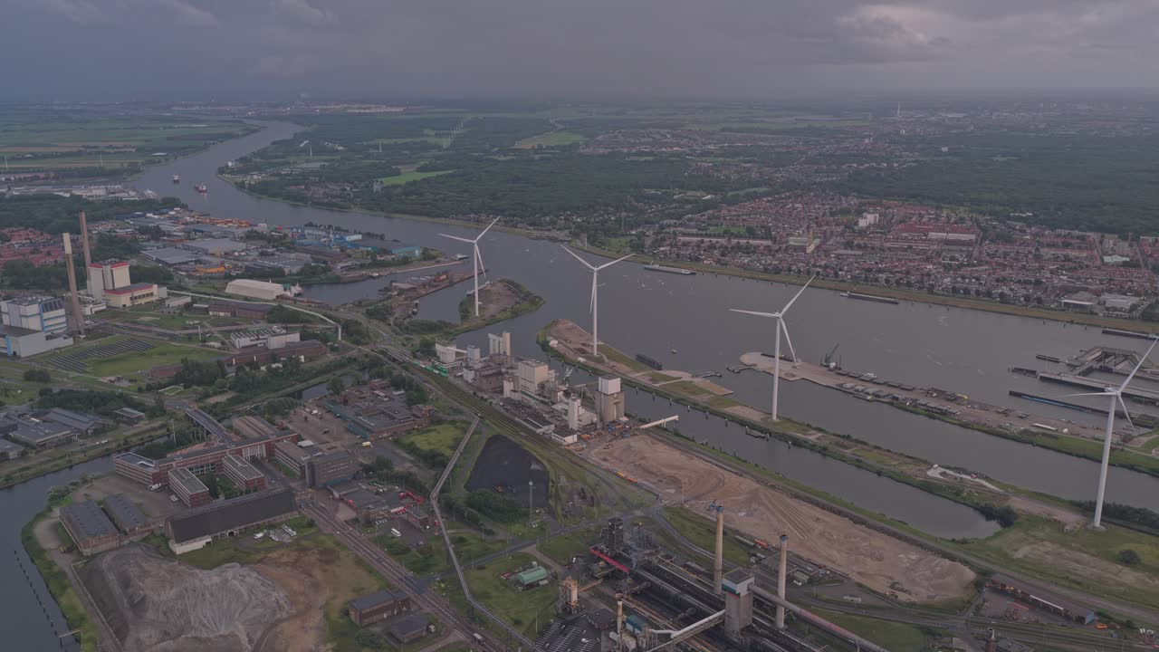 Aerial shot of smokestacks polluting in industrial zone at sunny dusk