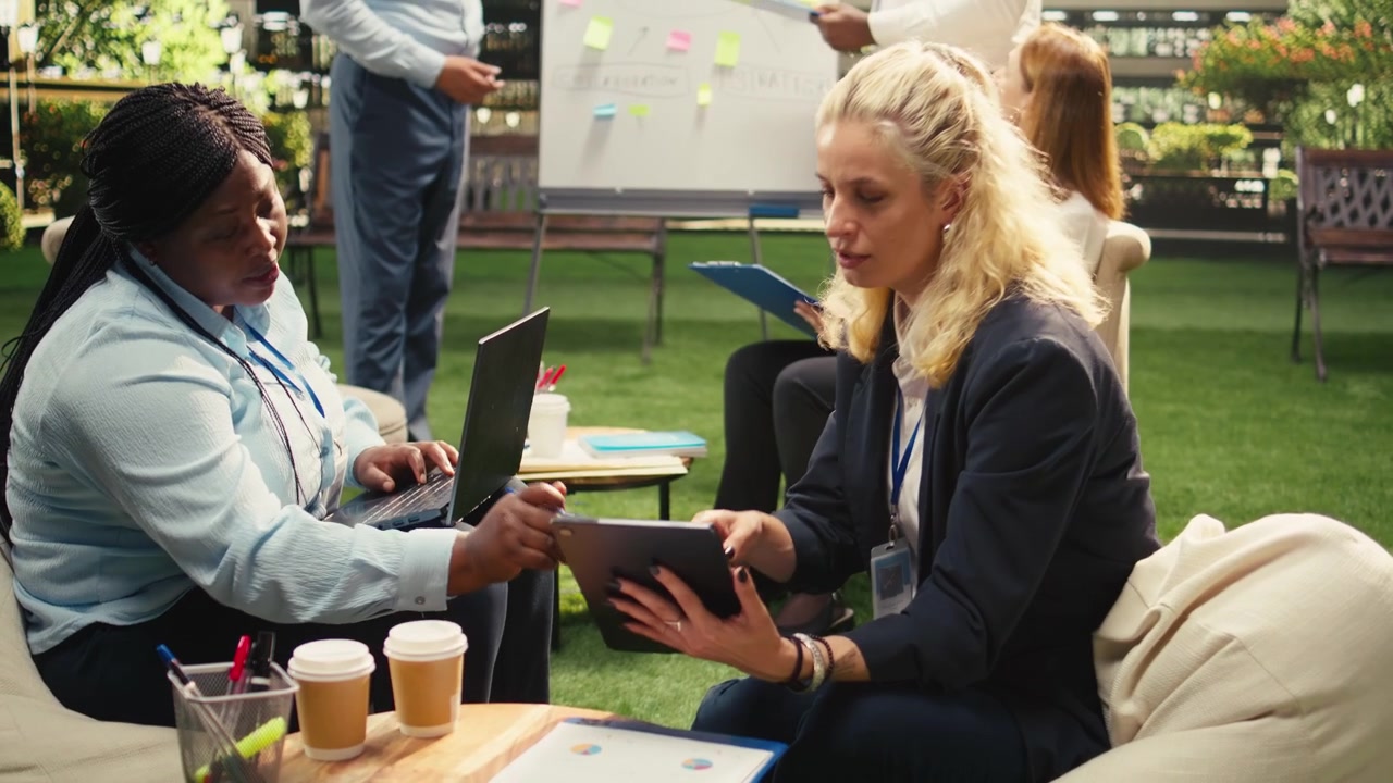 Diverse Business Colleagues Collaborating on Project in Modern Office Lounge