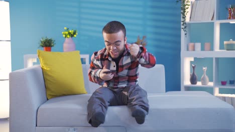 Delighted-dwarf-young-man-enjoying-a-successful-business-while-looking-at-the-screen-of-his-smartphone.