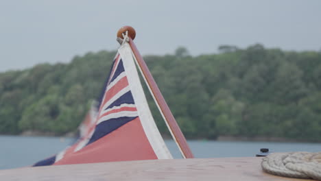 union jack flag flapping in the wind, stern of the boat in devon, england