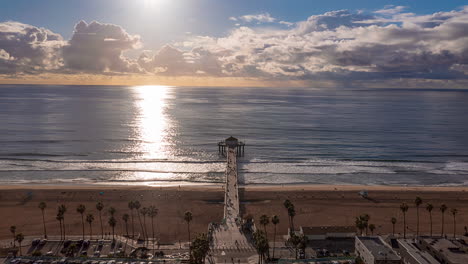 manhattan beach pier at sunrise on the coast of the pacific ocean in california, usa. timelapse