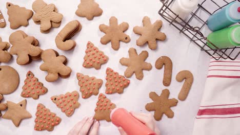 decorating gingerbread cookies with royal icing for christmas.