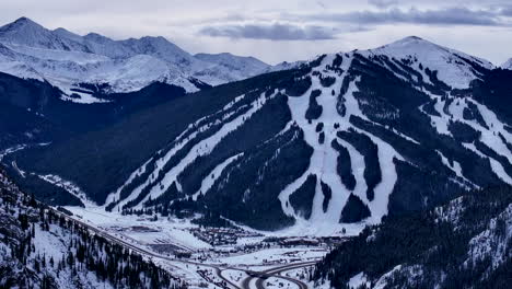 i70 copper mountain leadville colorado winter december christmas aerial drone cinematic ski runs trails distant landscape silverthorne vail aspen ten mile range cloudy rocky mountains slow forward