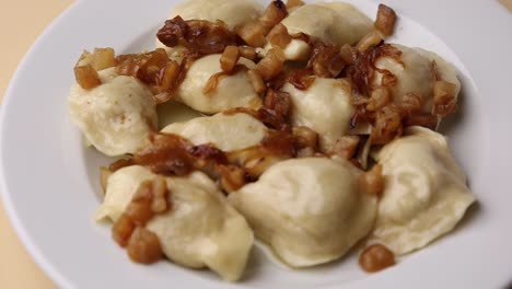 plate of pierogi with caramelized onions