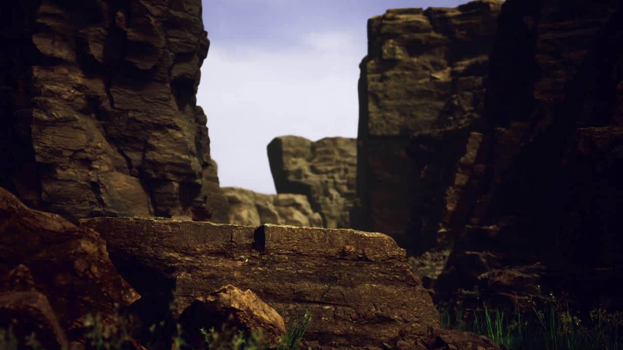 Rocky canyon landscape with dramatic cliffs and clear sky at sunset