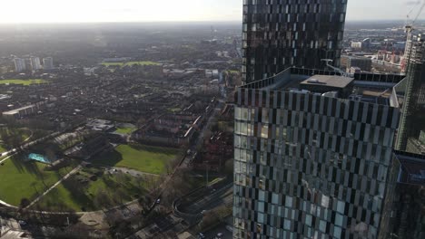 4K-60FPS-Aerial-drone-flight-passing-by-Elizabeth-Tower-showing-the-rooftop-and-a-park-situated-next-to-the-Mancunian-Way-in-Manchester-City-Centre