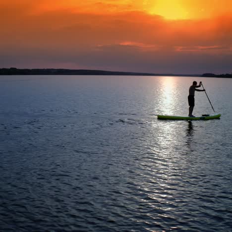 man on stand up paddle board. athlete man floating sup board on vacation